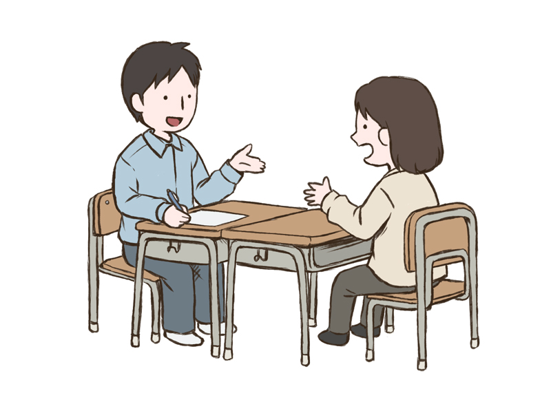 向かい合って話す先生と保護者